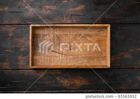 Rustic wooden box or container with copy space for text or food, top view flat lay , on old dark wooden table background Rustic wooden box or container with copy space for text or food, top view flat lay , on old dark wooden table background 83363932