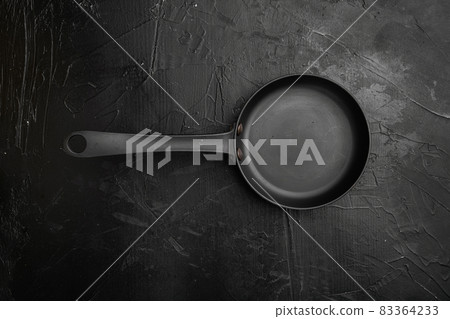 Large frying pan with copy space for text or food with copy space for text or food, top view flat lay , on black dark stone table background Large frying pan with copy space for text or food with copy space for text or food, top view flat lay , on black dark stone table background 83364233
