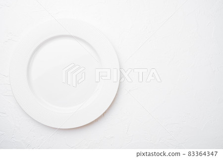 Ceramic empty white plate with copy space for text or food with copy space for text or food, top view flat lay , on white stone table background Ceramic empty white plate with copy space for text or food with copy space for text or food, top view flat lay , on white stone table background 83364347