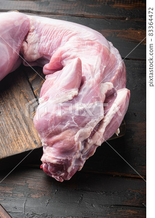 Whole raw rabbit meat, on old dark wooden table Whole raw rabbit meat, on old dark wooden table 83364472