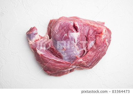 Raw pork cutlet steak. Piece of raw meat ready for preparation, on white stone table background, top view flat lay Raw pork cutlet steak. Piece of raw meat ready for preparation, on white stone table background, top view flat lay 83364473