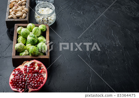 Gnarly garlic brussels ingredients, on black textured background with space for text Gnarly garlic brussels ingredients, on black textured background with space for text 83364475