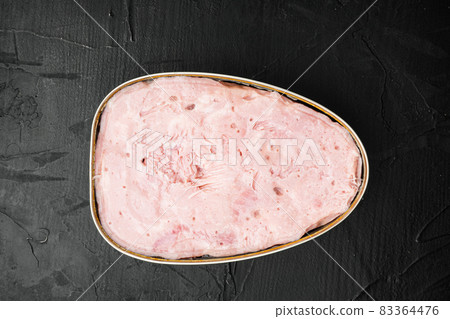 Ham in tin can, on black dark stone table background, top view flat lay Ham in tin can, on black dark stone table background, top view flat lay 83364476