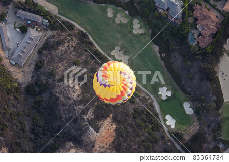 Top view of colorful hot air balloons on the sky over golf court. 83364784