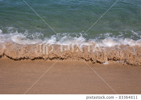 Close up of small wave on sand in tropical beach Close up of small wave on sand in tropical beach 83364811