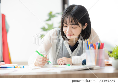 Young woman thinking about clothing design 83365225
