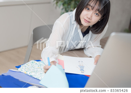 考慮服裝設計的年輕女性 考慮服裝設計的年輕女性 83365426