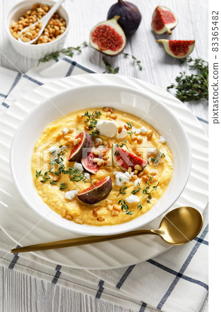 Pumpkin soup with feta, figs, pine nuts, top view Pumpkin soup with feta, figs, pine nuts, top view 83365482