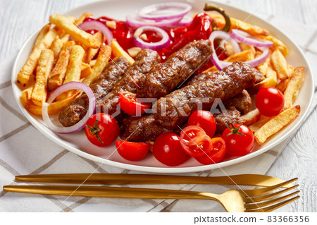 cevapcici with potato fries, red pepper, tomatoes cevapcici with potato fries, red pepper, tomatoes 83366356