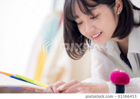 Fashion college student, a young woman sewing clothes 83366453