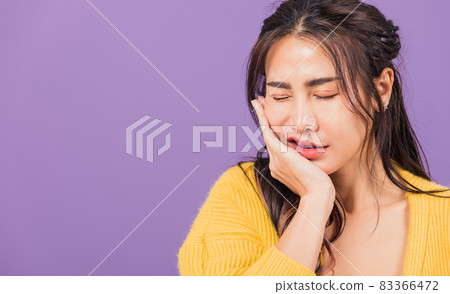 woman suffering from toothache, female terrible strong teeth pain problem pressing hand to chin woman suffering from toothache, female terrible strong teeth pain problem pressing hand to chin 83366472