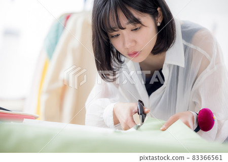 Fashion college student, a young woman sewing clothes Fashion college student, a young woman sewing clothes 83366561