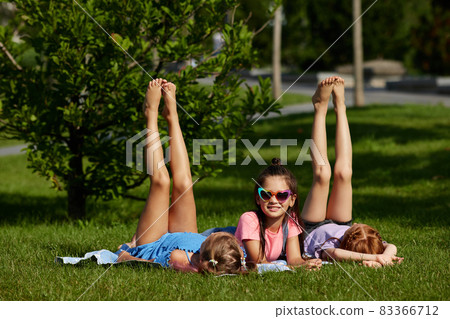 cute children girls playing together in the park cute children girls playing together in the park 83366712