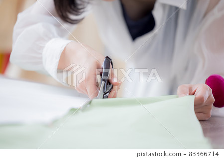 Fashion college student, a woman's hand cutting cloth with cutting scissors 83366714