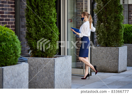 business woman in medical mask going to work 83366777