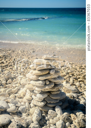 Pile of stones on the beach 83367033