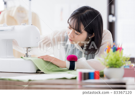 Fashion college student, a young woman sewing clothes 83367120