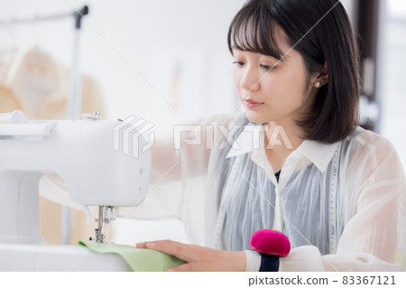 Fashion college student, a young woman sewing clothes 83367121