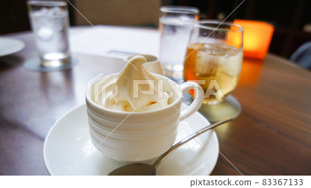 Soft serve ice cream in a white cup 83367133