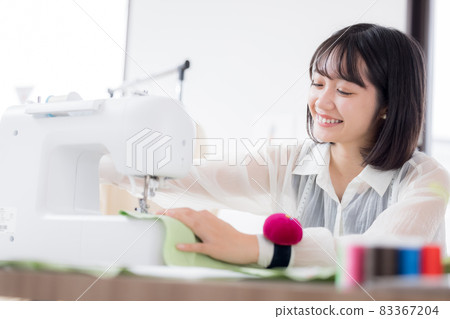Fashion college student, a young woman sewing clothes 83367204