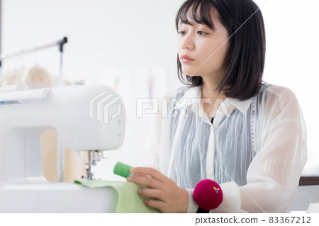Fashion college student, a young woman sewing clothes Fashion college student, a young woman sewing clothes 83367212