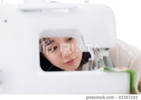 Fashion college student, a young woman sewing clothes Fashion college student, a young woman sewing clothes 83367283