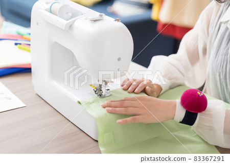 Fashion college student at hand of a young woman sewing clothes 83367291