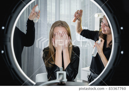 Woman in a beauty salon. Conceptual photo. Many hands doing hairdo Woman in a beauty salon. Conceptual photo. Many hands doing hairdo 83367760