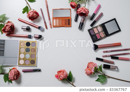 Decorative flat lay composition with cosmetics and flowers. Flat lay, top view on white background 83367767