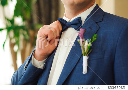 Wedding details. Groom accessories, A man in a jacket with a boutonniere. Wedding details. Groom accessories, A man in a jacket with a boutonniere. 83367985