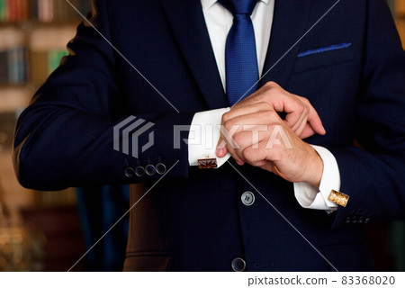 elegant businessman dressed costume before meeting with a partners elegant businessman dressed costume before meeting with a partners 83368020
