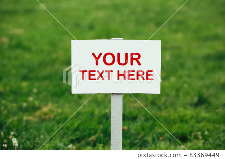 your text here sign against green grass background your text here sign against green grass background 83369449