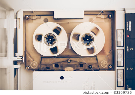 rewinding of vintage audio tape compact cassette, sepia tone rewinding of vintage audio tape compact cassette, sepia tone 83369726
