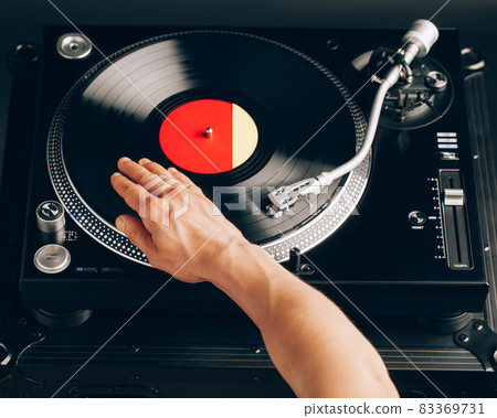 turntable scratch, hand of dj on the vinyl record turntable scratch, hand of dj on the vinyl record 83369731