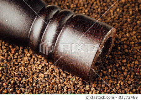 pepper mill on peppercorns background pepper mill on peppercorns background 83372469