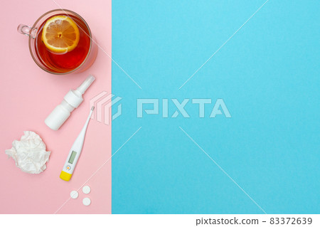Catch a cold. Flu season. Disease. Flat lay. Medical mask, pills, nasal spray, used wipes, thermometer, and lemon tea. Place for your text. Copy space. Mockup. Seasonal cold concept. Health care. Catch a cold. Flu season. Disease. Flat lay. Medical mask, pills, nasal spray, used wipes, thermometer, and lemon tea. Place for your text. Copy space. Mockup. Seasonal cold concept. Health care. 83372639