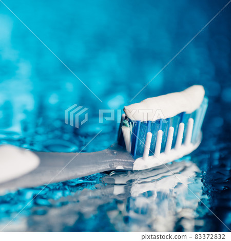 toothbrush on blue background with water drops toothbrush on blue background with water drops 83372832