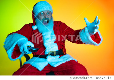 Portrait of senior man, surprised Santa Claus sitting and watching movie at cinema, indoors. Happy New Year 2022, Christmas concept Portrait of senior man, surprised Santa Claus sitting and watching movie at cinema, indoors. Happy New Year 2022, Christmas concept 83373917