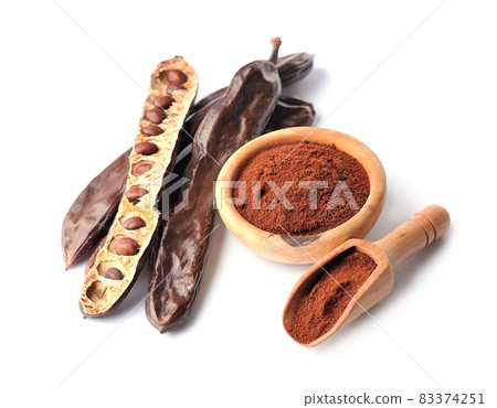Carob pod and carob powder on white backgrounds. Carob pod and carob powder on white backgrounds. 83374251