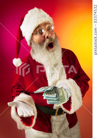 Portrait of surprised Santa Claus wishes wealth and prosperity to every family in New Year 2022. Holidays concept 83374532