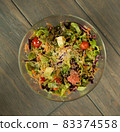 Top view fresh vegetable salad glass bowl wooden table 83374558