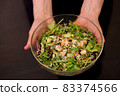 Top view fresh salad with vegetables and meat females hands holding big bowl 83374566