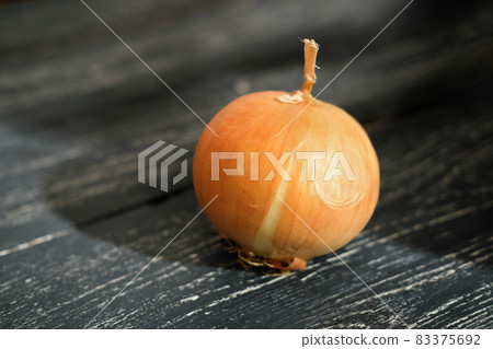 onion bulb on a rustic wooden grey table. onion bulb on a rustic wooden grey table. 83375692