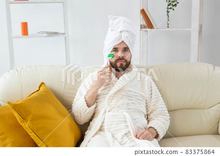 Bearded man with facial massage tool. Male skin care and spa concept. 83375864