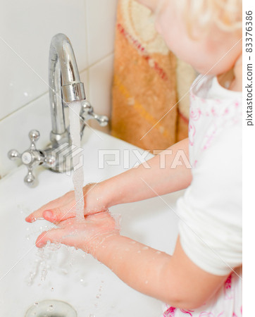 Little girl washing hands Little girl washing hands 83376386
