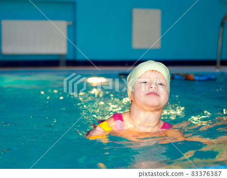 Child in a swimming pool Child in a swimming pool 83376387
