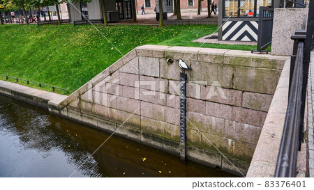 Stone pillar and water level meter on the river Stone pillar and water level meter on the river 83376401