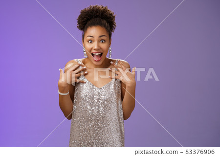Amazed surprised attractive african-american young woman in glittering evening night dress scream happiness pointing herself amused cannot believe lucky win casino lottery, blue background 83376906