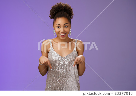 Excited surprised charming glamour african-american woman elegant silver glittering dress smiling wondered touched pointing down index fingers widen eyes astonished pleased awesome present Excited surprised charming glamour african-american woman elegant silver glittering dress smiling wondered touched pointing down index fingers widen eyes astonished pleased awesome present 83377013