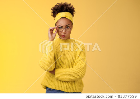 Suspicious strict serious-looking attractive clever african-american female student check glasses smirking disapproval frowning displeased bad classmate behaviour standing doubtful look disbelief Suspicious strict serious-looking attractive clever african-american female student check glasses smirking disapproval frowning displeased bad classmate behaviour standing doubtful look disbelief 83377559